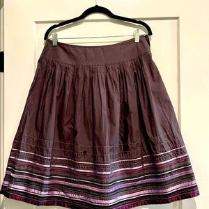 Plum colored skirt.